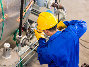 Technician performing maintenance on a machine.