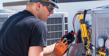 Man servicing HVAC unit