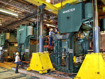 Technicians preparing to move heavy equipment at a facility.